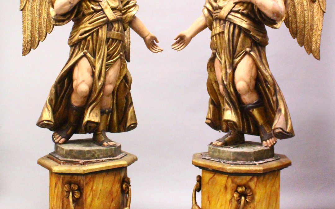 A large pair of carved, painted and gilded figures of standing angels/Auctioneers and Valuers