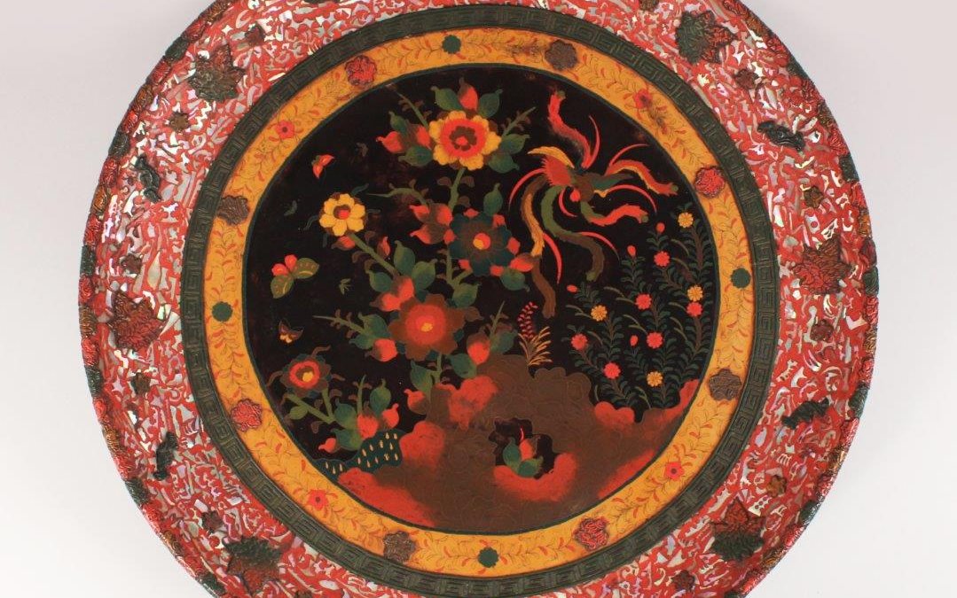 A rare Japanese ceramic plaque with a totei cloisonné centre and cinnabar lacquer. /Auctioneers and Valuers