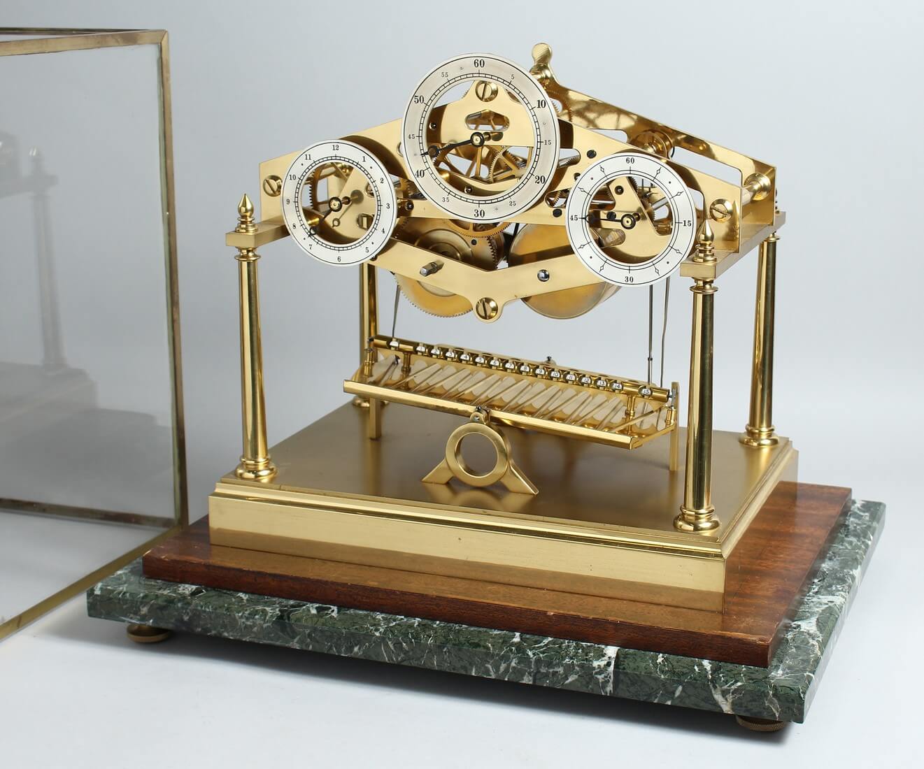 Andrew Fell, a limited edition lacquered brass architectural design rolling ball clock, with three silvered chapter rings,