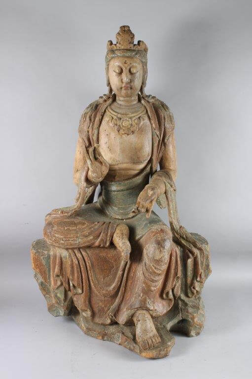 A large Chinese carved and painted wooden figure of Guanyin. An auction of important Oriental w
