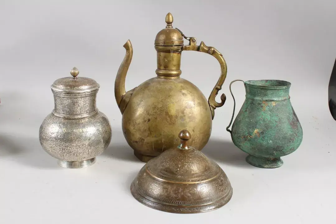 A collection of four Islamic, possibly Persian metalworks.