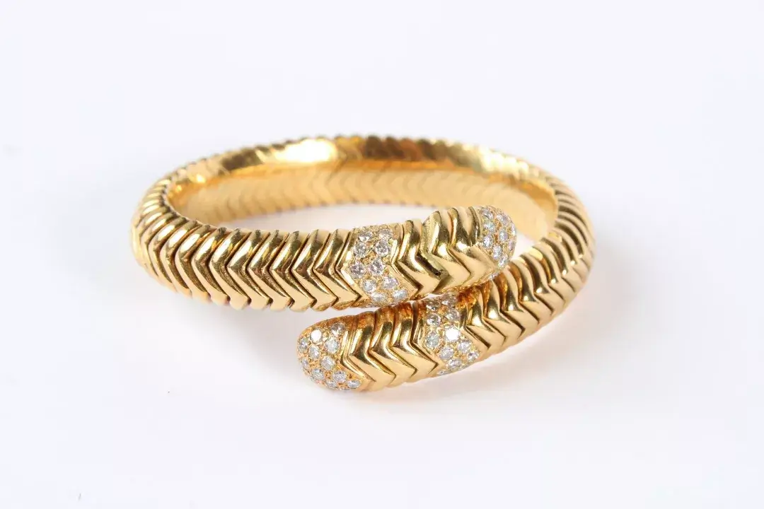 A good 18K gold and diamond snake bangle. 58.6grams. Fine